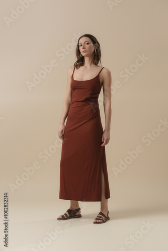 Serie of studio photos of young female model in brown cotton camisole dress. Classic and simple summer fashion.	