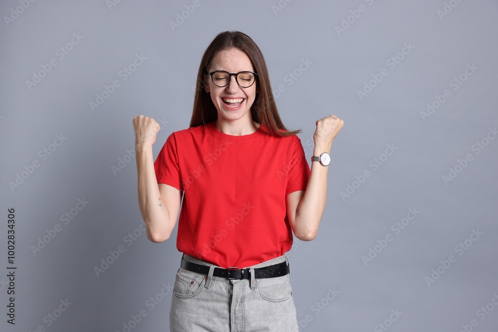 Portrait of happy winner on gray background