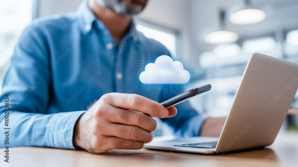A professional using a smartphone and laptop with a floating cloud icon, representing cloud technology, data transfer, and remote access. A professional using a smartphone and laptop with a floating cloud icon, representing cloud technology, data transfer, and remote access.