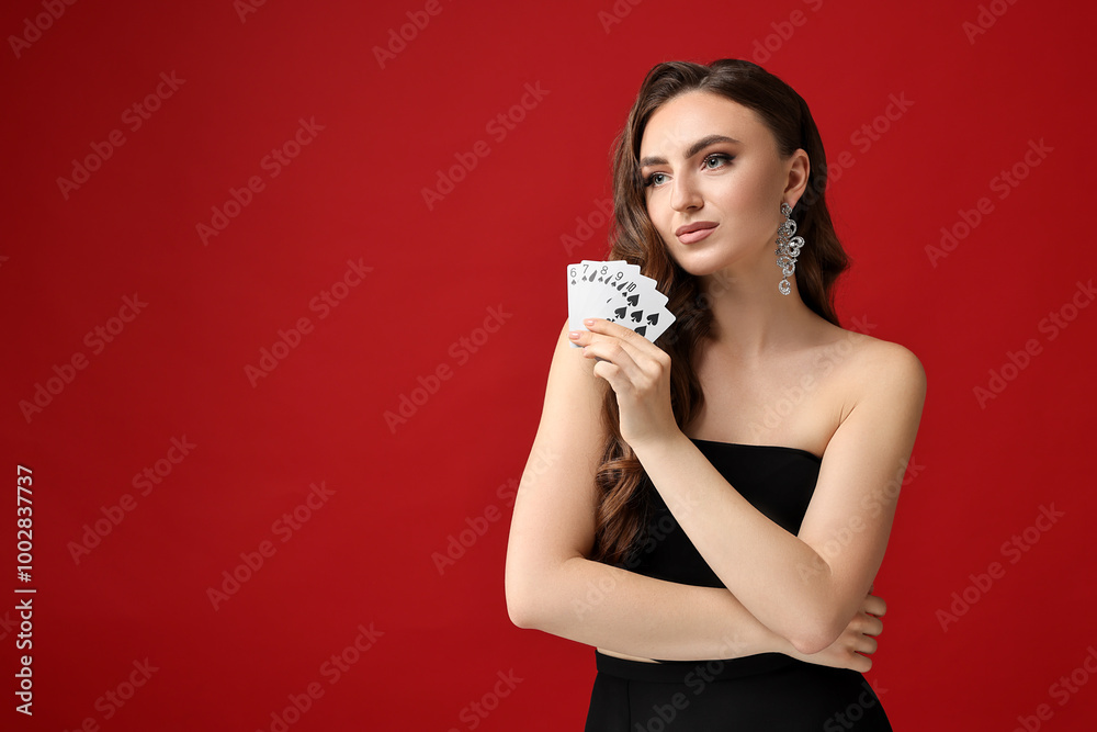 Poker game. Charming woman with playing cards on red background. Space for text Poker game. Charming woman with playing cards on red background. Space for text