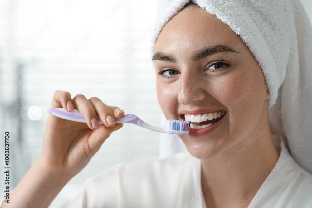 Beautiful woman brushing her teeth in bathroom Beautiful woman brushing her teeth in bathroom