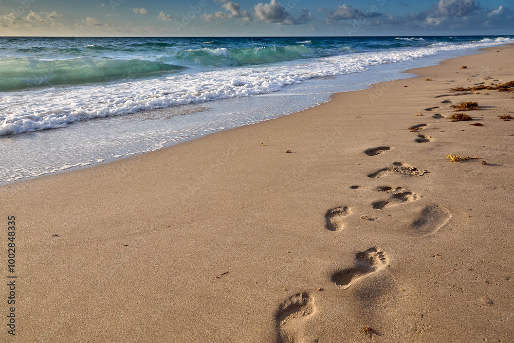 Early walK on a sandy beach finding peace where the ocean meets the sky.  Delray Beach Florida