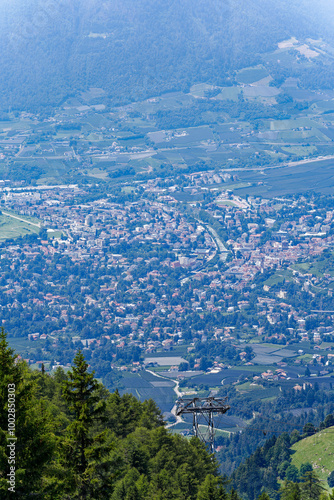 Aerial view of Italian City of Meran with Etsch Valley and Etsch River seen from mountain resort Meran 2000 on a sunny summer day. Photo taken July 18th, 2024, Meran Merano, Italy.