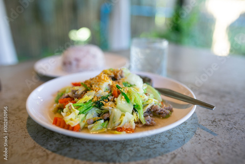 Stir-fried rice noodle with pork and vegetable on plate. Thai food.
