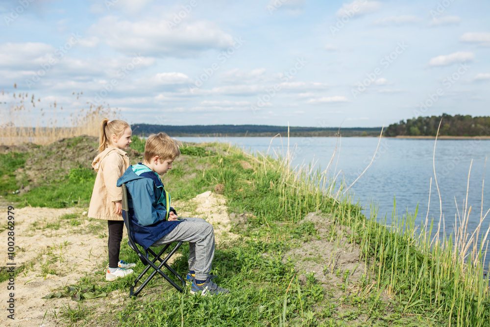 Children Enjoying Nature by Riverbank. Children Enjoying Nature by Riverbank.