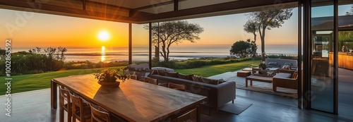 A beautiful outdoor patio with a table and chairs, and a view of the ocean