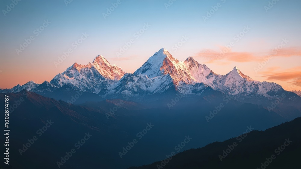 Fototapeta premium As the sun sets, the mountain range is bathed in warm hues of orange and pink, creating a serene and breathtaking view that captivates nature lovers and adventurers alike