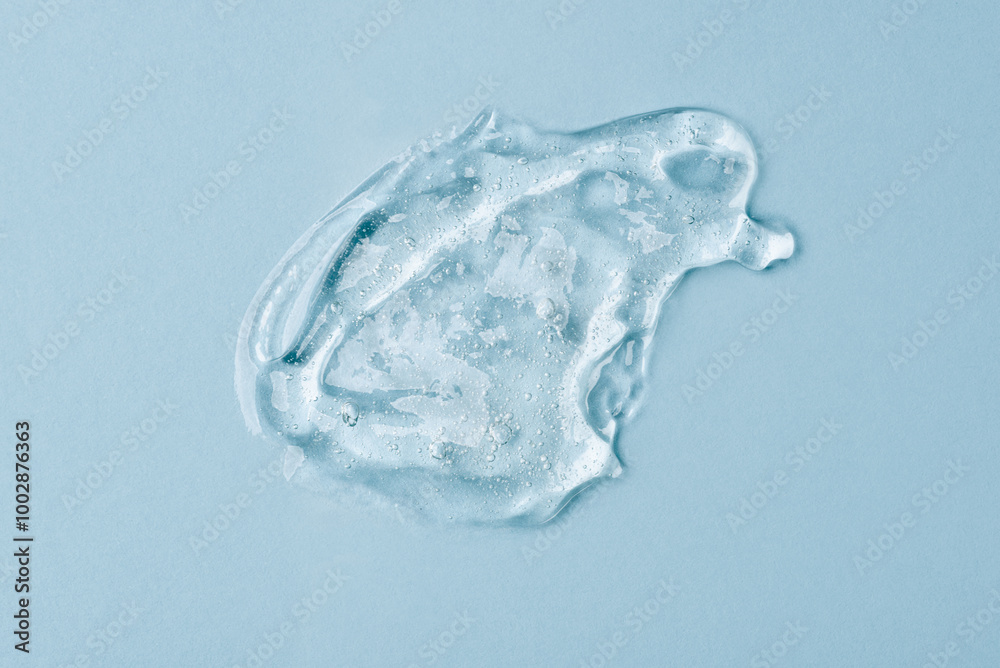 Transparent Skin care Product Smear on Blue Background Transparent Skin care Product Smear on Blue Background