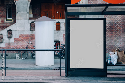 Fototapeta Naklejka Na Ścianę i Meble -  Public transport station billboard with blank copy space screen for advertising text message,promotional content, empty mock up Lightbox for information, stop clear poster display in urban city street