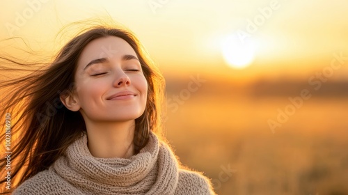 A serene woman enjoying a sunset in a field, radiating peace and happiness.