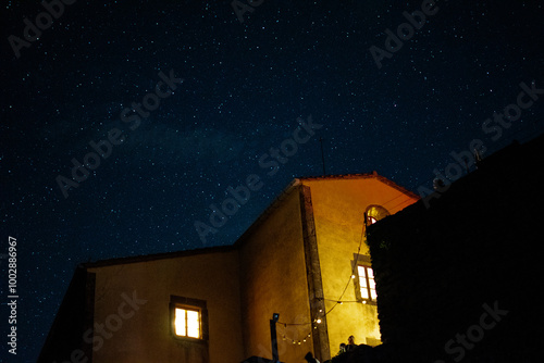 Cielo estrellado nocturno con inglesia iluminada, santuario iluminado photo