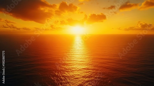 Capture the birds-eye view of a golden sunset over a vast ocean, highlighting the warm golden glow