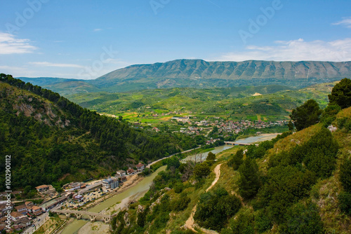 View of Gorica quarter of Berat, Albania taken from Berat Castle. UNESCO listed, known as City of a 1000 Windows. Mali Partizan Mountain left, Osum river crossed by Gorica Bridge foreground. 