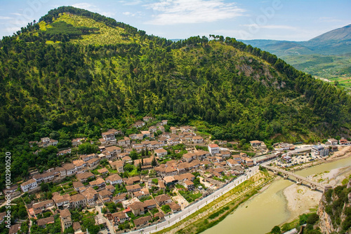 Gorica quarter of Berat, Albania, taken from Berat Castle. UNESCO listed, known as City of a Thousand Windows. Mali Partizan Mountain background, Osum river crossed by Gorica Bridge foreground