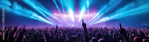 A vibrant concert scene featuring enthusiastic fans with raised hands, illuminated by colorful stage lights and dynamic atmosphere.