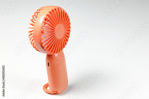 Small plastic Portable fan side view, isolated on white background.