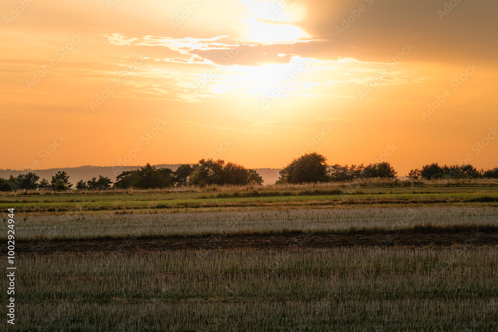 Beautiful sunset over the field after harvest. Susiec, Roztocze, Poland