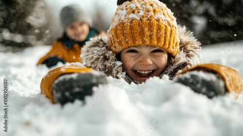 A cheerful child in bright winter gear laughing while playing in the snow, capturing the essence of joy and childhood innocence in a snowy environment. photo