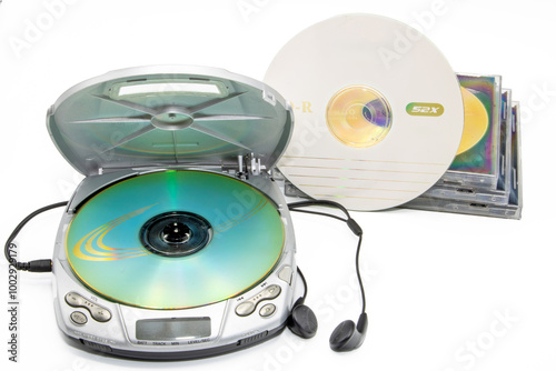 Close-up of a discman with cd cases next to it isolated on white background