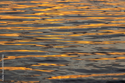 orange sunset is reflected in the water of the lake