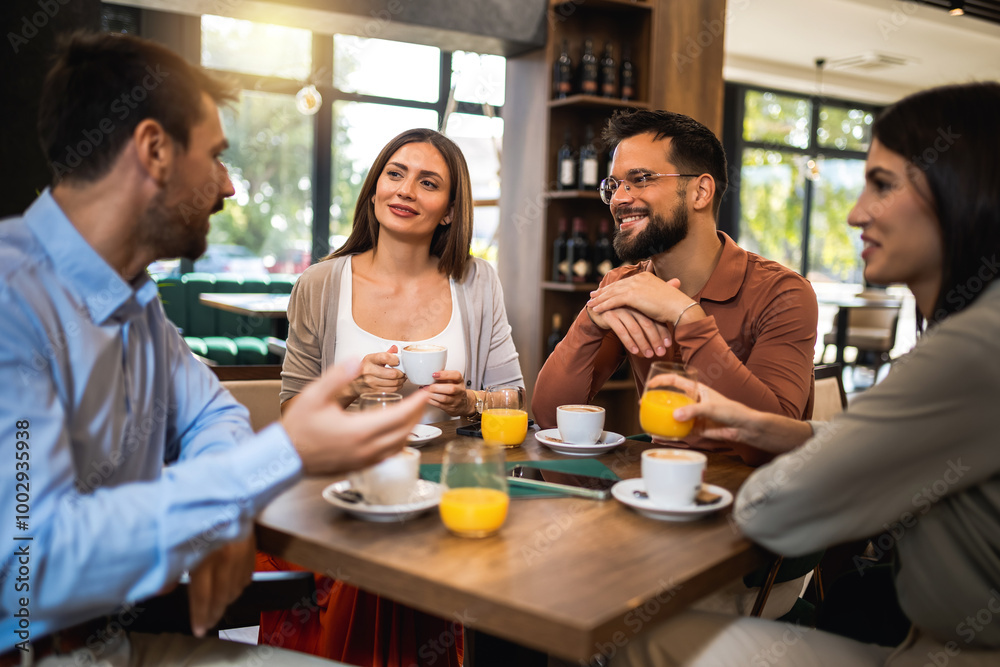 Group of friends chilling at the cafe. Talking, drinking coffee and orange juice.