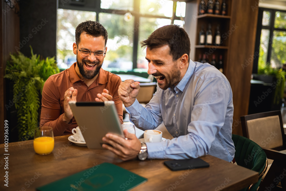 Two colleagues hanging out at the coffee shop. Working together on tablet. Two colleagues hanging out at the coffee shop. Working together on tablet.