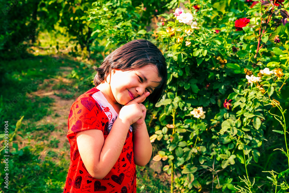 little girl in summer garden posing among flowers little girl in summer garden posing among flowers
