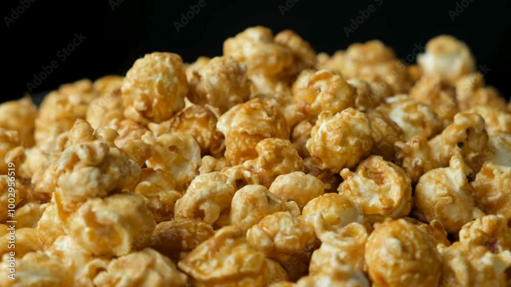 Rotation of caramelized popcorn, black background Rotation of caramelized popcorn, black background