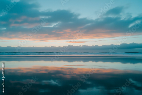 Serene sunset beach scene with pastel hues painting the sky and gentle waves lapping against the shore