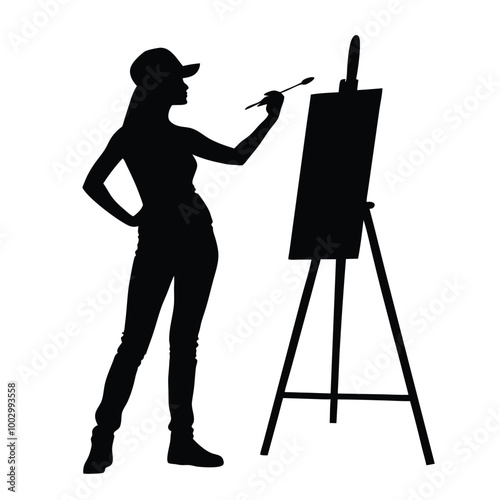 a black silhouette of a woman standing in front of an easel. She is holding a paintbrush in her right hand and appears to be in the process of painting or drawing on the canvas 