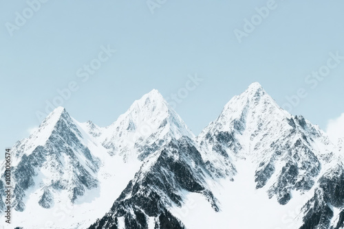 Majestic snow capped mountains under clear blue sky inspiring tranquility and adventure