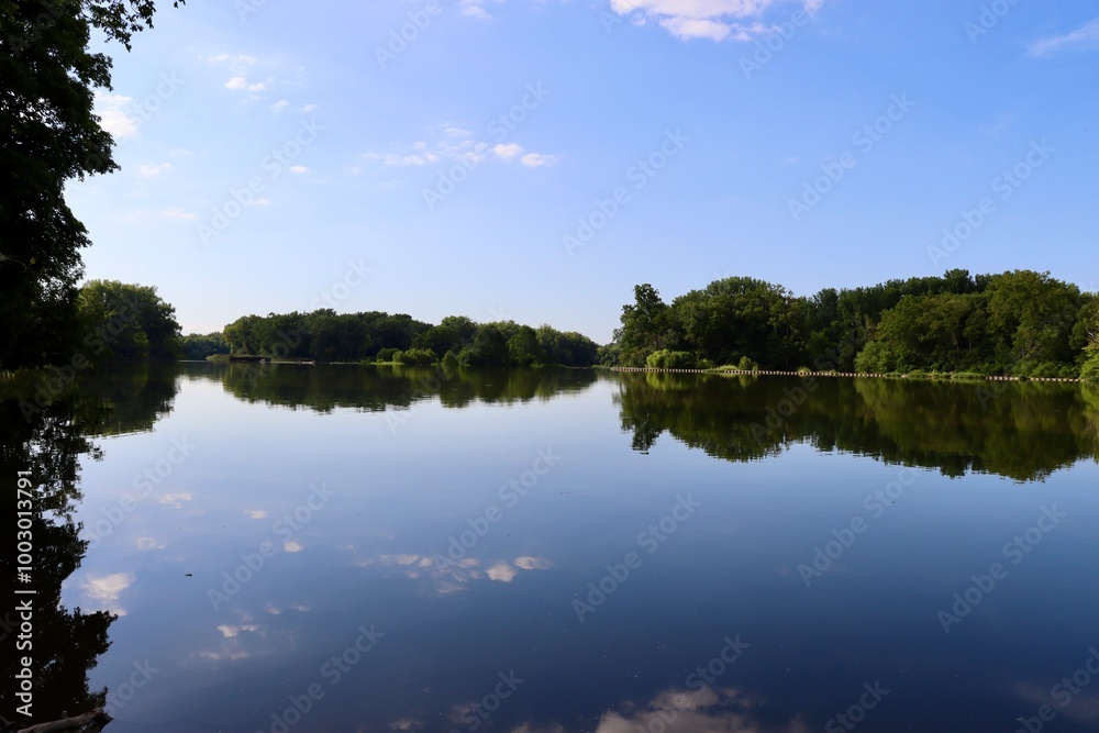 The calm river in the countryside on a sunny day. The calm river in the countryside on a sunny day.