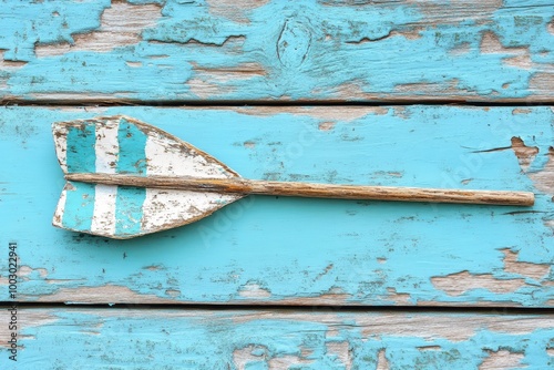 Vintage paddle on weathered blue wooden background photo