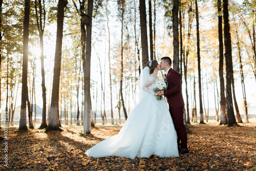 Two women are posing for a picture, one of them is wearing a wedding dress. Scene is happy and celebratory