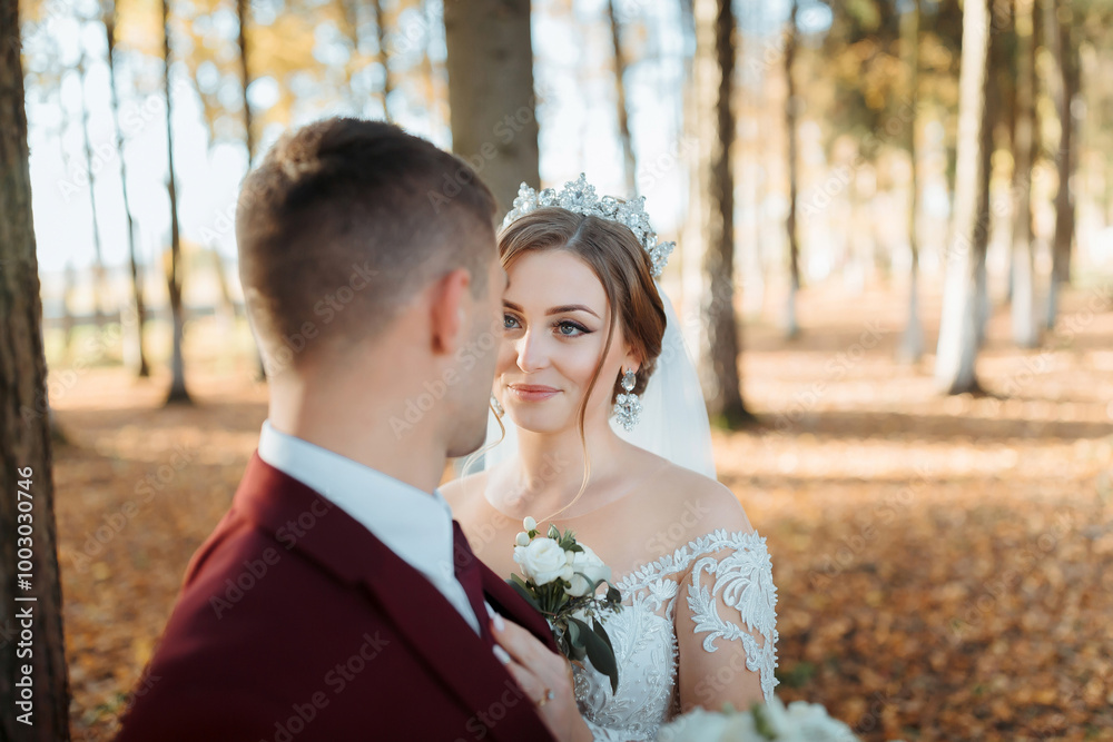 A bride and groom are standing in a forest, with the bride wearing a tiara. Scene is romantic and intimate A bride and groom are standing in a forest, with the bride wearing a tiara. Scene is romantic and intimate
