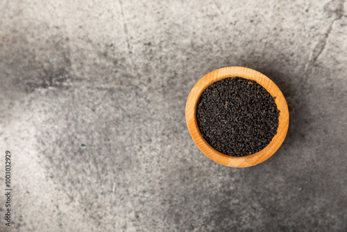 Basil seeds on textured wooden background. Close-up. Superfood. Ocimum basilicum. Organic basil seeds. selasih. Space for text. Copy space. photo