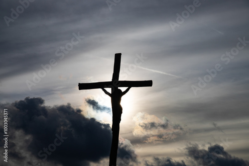 Passion Week cross silhouette with dramatic sky symbolizing the sacrifice, suffering, death, resurrection and passion of Jesus