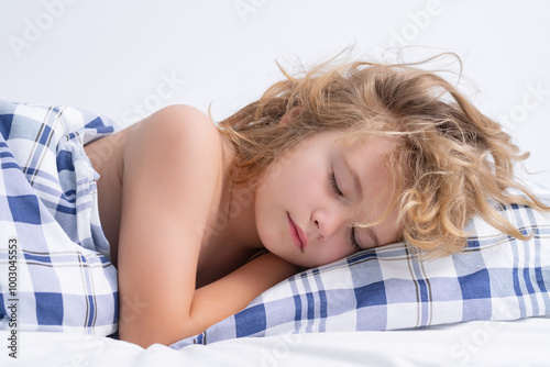 Bedding child. Kid sleeping in bed. Child sleeping under blanket, lying on pillow. Child rest asleep, enjoy healthy sleep or nap. photo