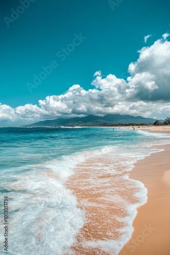 Tranquil beach with gentle waves and fluffy clouds under a bright blue sky on...