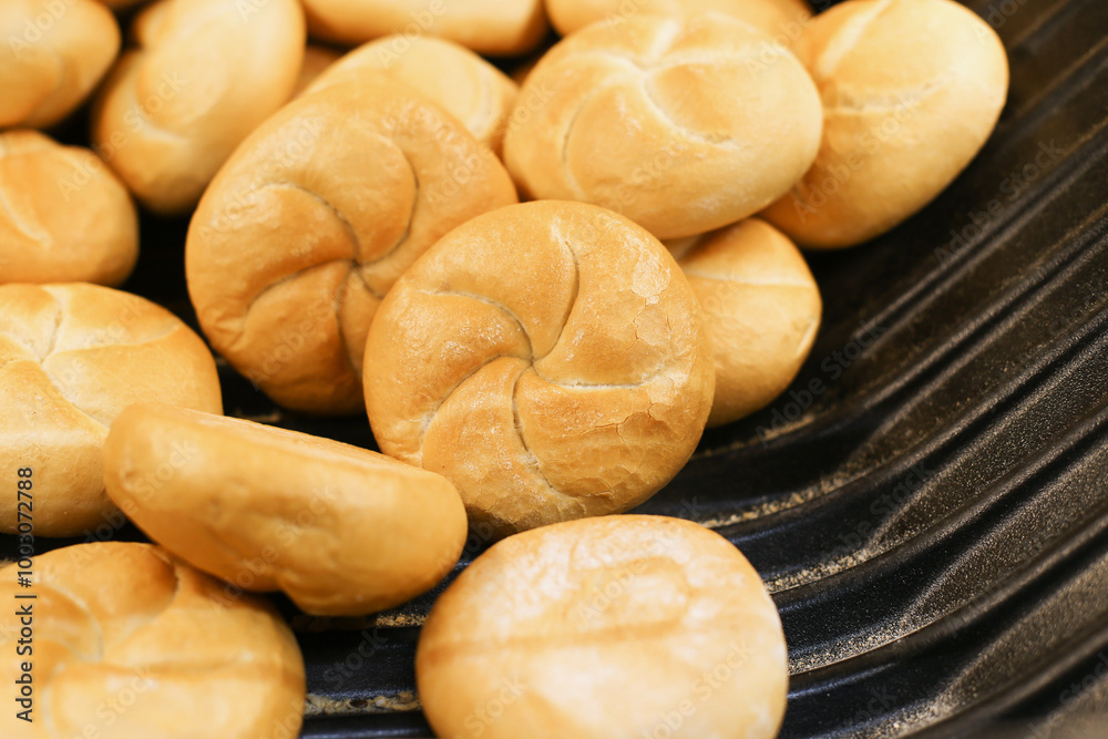 Fresh Kaiser rolls stacked on a store shelf. Group of classic bread rolls on display. Bakery section with a pile of golden brown buns. Perfect for sandwiches or breakfast. Crisp, freshly baked roll. Fresh Kaiser rolls stacked on a store shelf. Group of classic bread rolls on display. Bakery section with a pile of golden brown buns. Perfect for sandwiches or breakfast. Crisp, freshly baked roll.