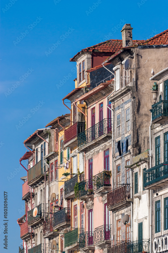 Obraz premium Close up of the famous riverside buildings in Porto. Colorful facades with colored steel balconies. on a sunny day