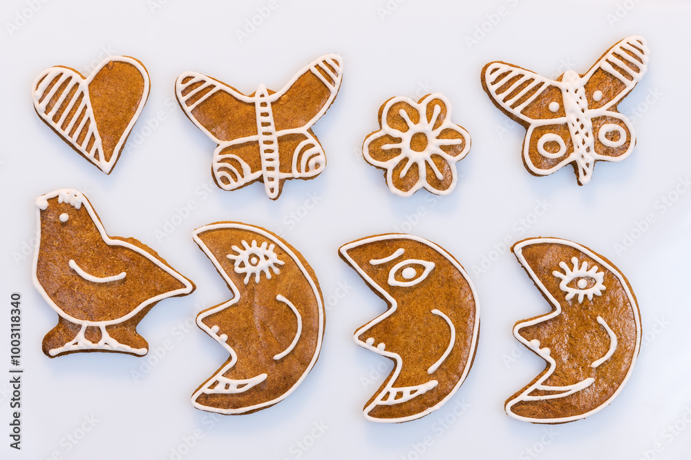 Closeup of aromatic decorated gingerbread cookies on white background. Set of cute baked moons or butterflies and sweets in bird, heart or flower shape. Traditional Czech Christmas or New Year pastry. Closeup of aromatic decorated gingerbread cookies on white background. Set of cute baked moons or butterflies and sweets in bird, heart or flower shape. Traditional Czech Christmas or New Year pastry.