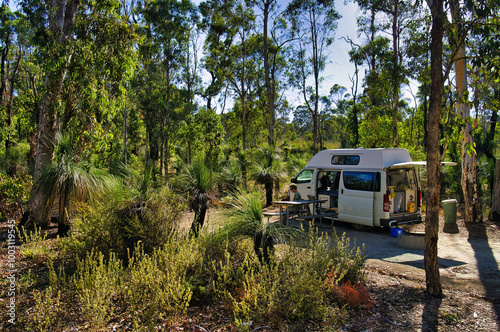 Camping with a small rv in an idyllic spot with grass trees and eucalyptus in Avon Valley National park, close to Perth, Western Australia.
