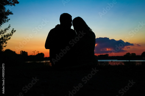 happy couple silhouette against a sunset romance photo