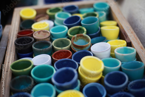 multi-colored ceramic cups, sale of souvenirs photo