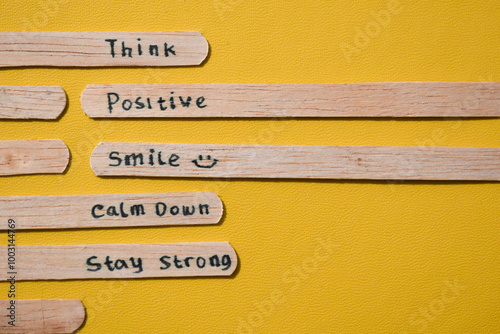 stick of ice cream with the words Think Positive, Smile, calm dowm, Stay strong. Motivational quotes, optimism, positive words. Isolated on background photo