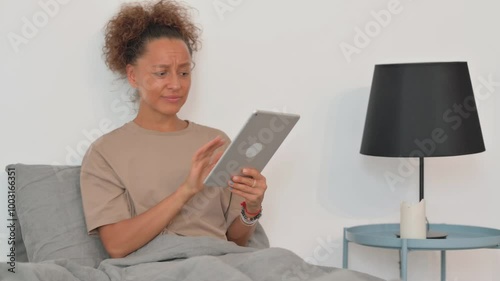 Hispanic Woman Shocked by Loss on Tablet while in Bed                                                                          ptop Outdoor photo