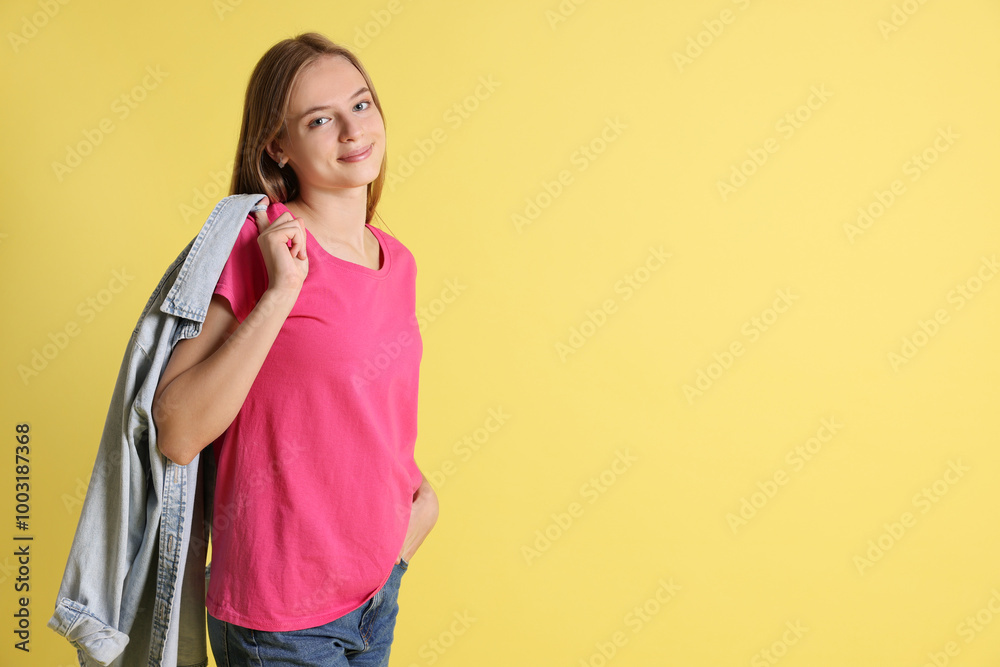 Teenage girl with denim jacket on yellow background, space for text Teenage girl with denim jacket on yellow background, space for text