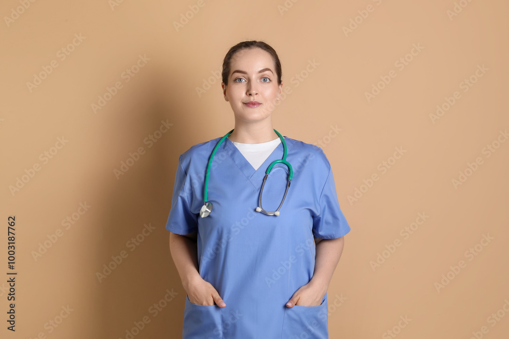 Portrait of professional nurse with stethoscope on dark beige background Portrait of professional nurse with stethoscope on dark beige background