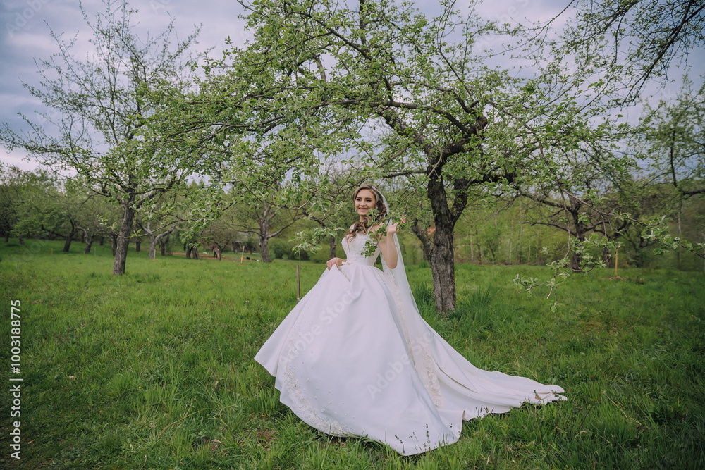 A woman in a white dress is standing in a field of green grass. She is smiling and she is enjoying herself A woman in a white dress is standing in a field of green grass. She is smiling and she is enjoying herself